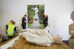 Technicians install Scott Statue display