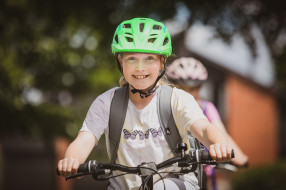 Happy kids biking to school in Christchurch