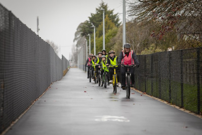 School children and adult cycling on the Northern Line cycleway